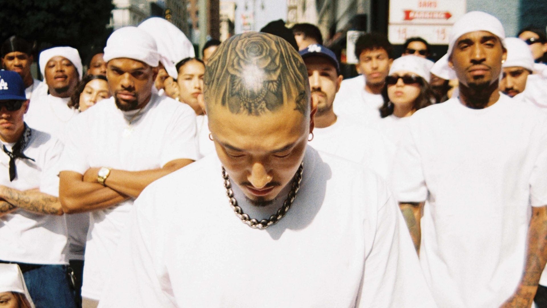 Crowd dressed in matching white tees on a downtown Los Angeles street